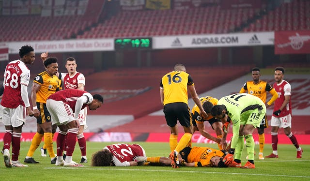 David Luiz of Arsenal and Wolves' Raul Jimenez lie on the ground after a clash of heads