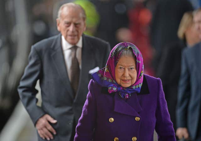 The Queen and the Duke of Edinburgh alight from a train at King’s Lynn station in Norfolk ready for their Christmas break (Joe Giddens/PA)