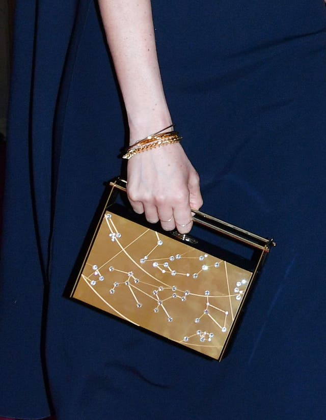 Ms Markle carried a clutch bag decorated with constellations (John Stillwell/PA)