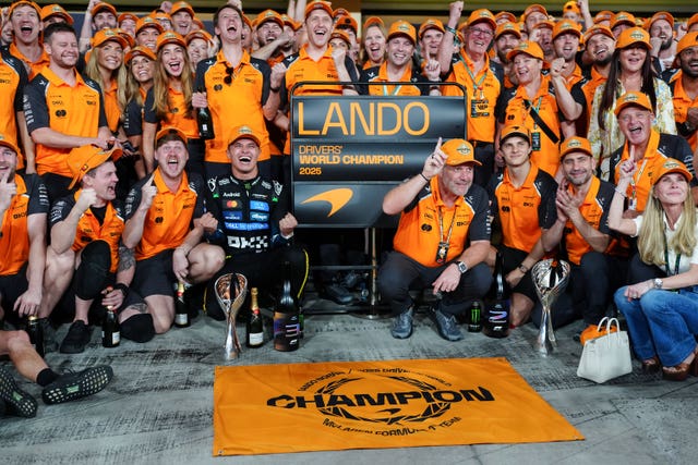Norris and his team, including team-mate Oscar Piastri and chief executive Zak Brown, celebrate in Abu Dhabi