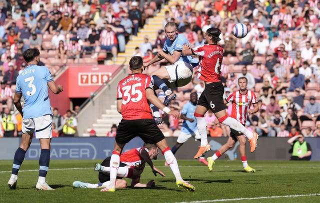 Manchester City’s Erling Haaland climbs high to plant a header towards goal