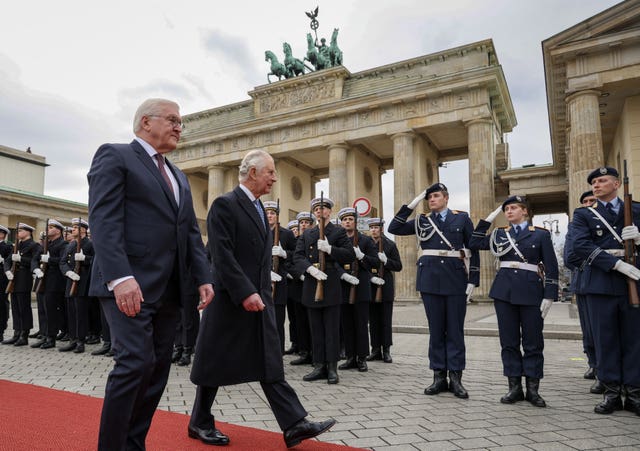 German President Frank-Walter Steinmeier (left) and the King inspect a guard of honour during the ceremonial welcome at Brandenburg Gate, Berlin