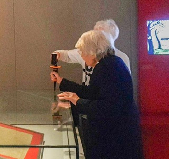 Judy Bruce (hidden), 85, a retired biology teacher from Swansea and Reverend Sue Parfitt, 82, from Bristol, as they target the protective enclosure around the historic Magna Carta document with a hammer and chisel on Friday morning at the British Museum