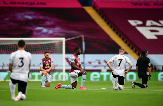 Players and officials took a knee in support of the Black Lives Matter movement after the whistle was blown for kick-off