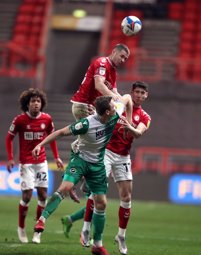 Bristol City's Tommy Rowe rises highest to win a header during his side's Championship match against Millwall 