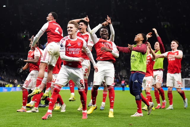 Arsenal players celebrate seeing off Tottenham