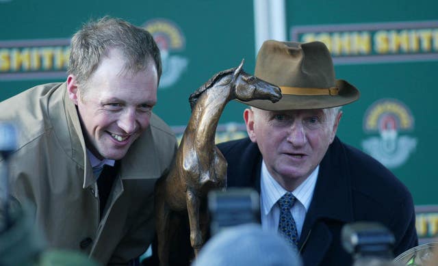 David Pipe collects his trophy with his father Martin Pipe after Comply Or Die's victory in the Grand National