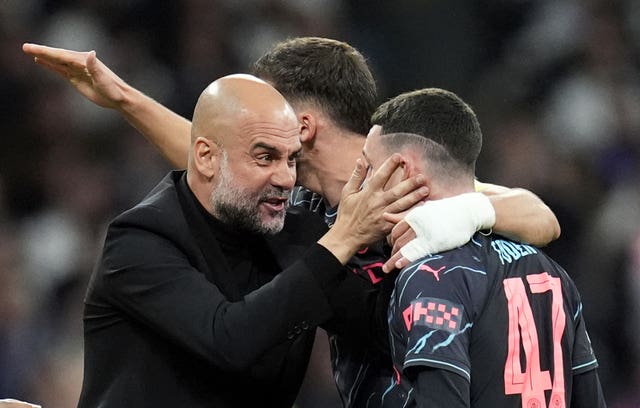 Pep Guardiola celebrates with Phil Foden