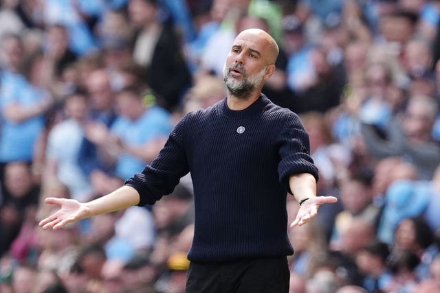 Pep Guardiola gestures on the touchline during a Manchester City game