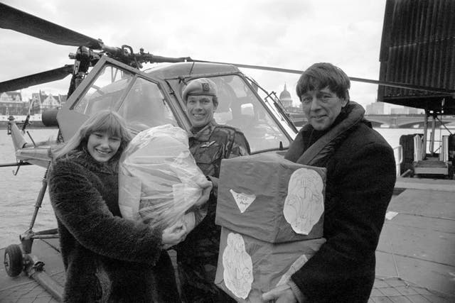 Blue Peter presenters Lesley Judd and John Noakes receive a special delivery from Captain Mike Bell of the Third Regiment, Army Air Corps, Wiltshire, containing 30,000 stamps for Blue Peter's Lifeline Lebanon Appeal. (Image: PA)