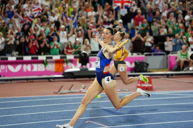 Amy Hunt celebrates crossing the finish line