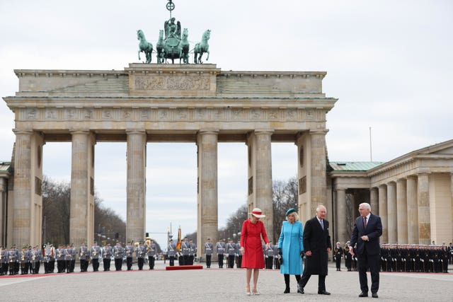 German President Frank-Walter Steinmeier, right, and his wife Elke Buedenbender, left, with the King and the Queen Consort during the ceremonial welcome at the Brandenburg Gate, Berlin, at the start of their state visit to Germany