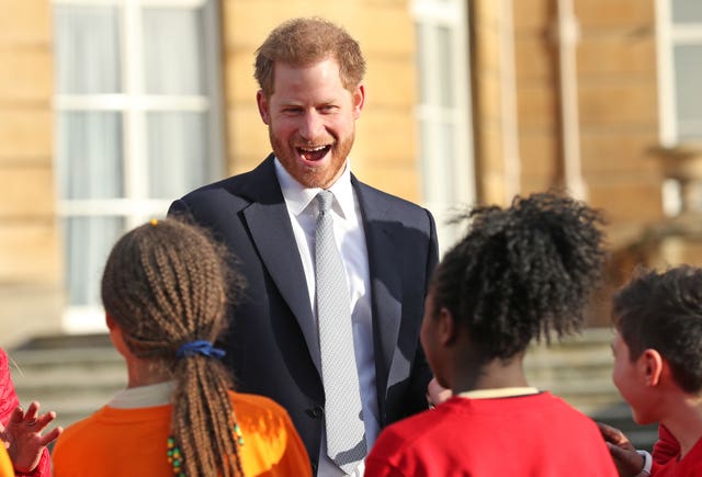 The Duke of Sussex meets children in the Buckingham Palace gardens