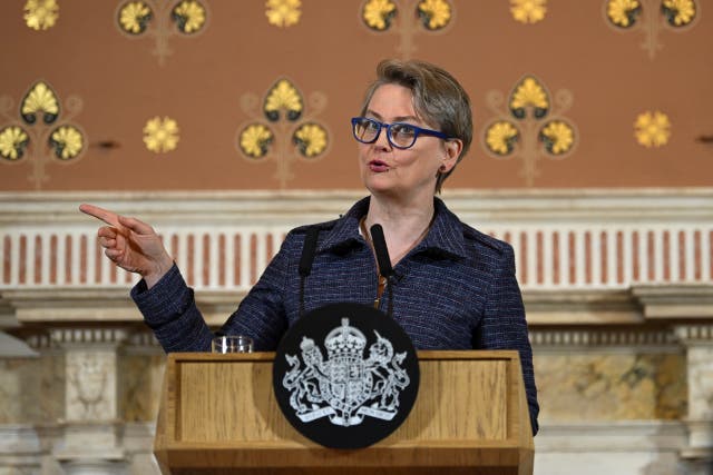 Yvette Cooper gesturing with her right hand as she speaks from behind a lectern