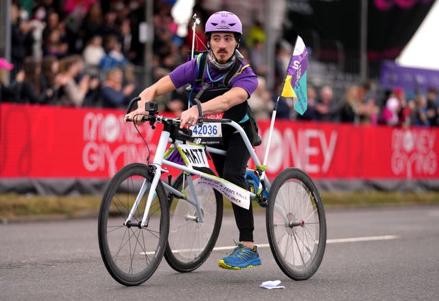 Matt Humphreys using a frame runner to run for Scope Charity