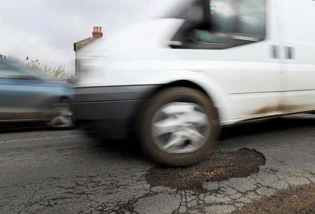 A van passes over a large pothole near Ashford, Kent