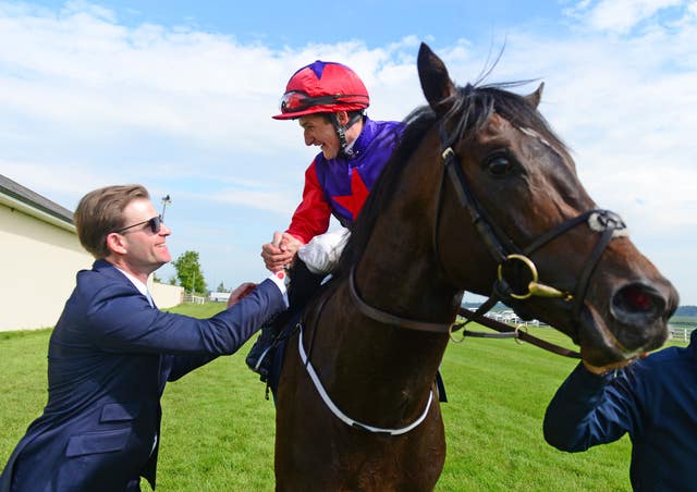 Romanised and jockey Shane Foley are greeted by trainer Ken Condon after winning the Irish 2000 Guineas