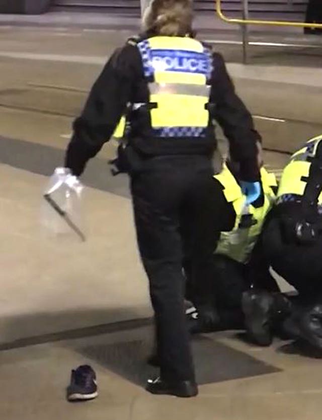 A police officer holding an evidence bag containing a knife following the attack (Sam Clack/PA)