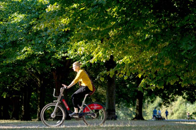 A cyclist rides through Kensington Gardens