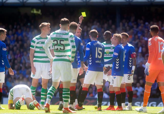 Jon Flanagan is booked during the Old Firm derby