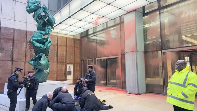 People around a statue during a Prisoners for Palestine protest