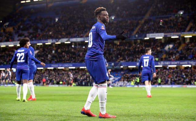 Hudson-Odoi discards a foreign object which was thrown onto the pitch