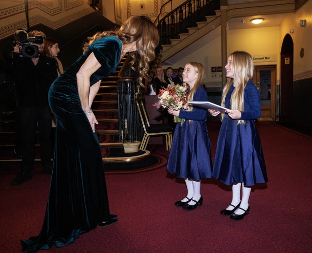 The Princess of Wales being presented with flowers by twins Emelia (centre) and Olivia Edwards