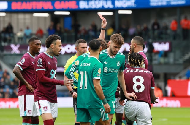 Referee Michael Oliver shows a red card to Burnley’s Lesley Ugochukwu