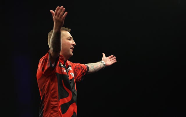 Nathan Aspinall raises his arms in the air to the crowd