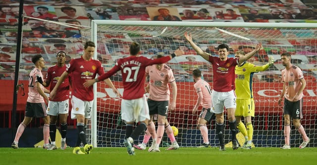 Harry Maguire, centre right, appeals after being penalised for a foul which denied Anthony Martial, second left, a goal