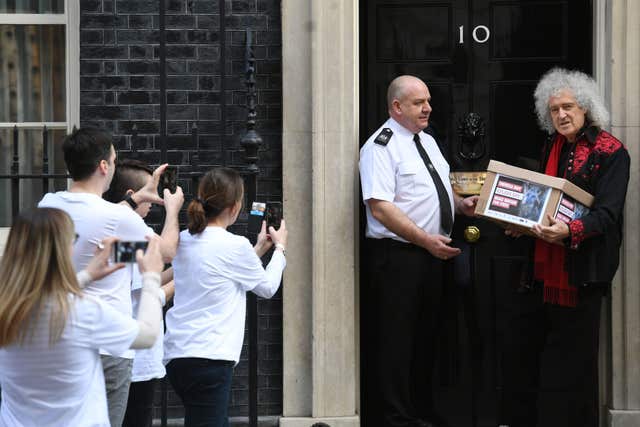 May joined animal protection campaigners at No 10 to hand in the 400,000 -strong petition (Stefan Rousseau/PA)