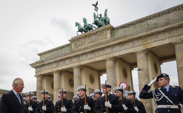 The King inspects a guard of honour during the ceremonial welcome at the Brandenburg Gate, Berlin, at the start of his state visit to Germany