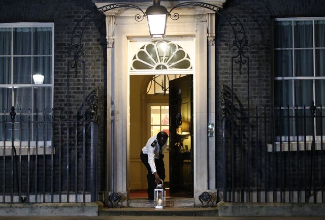A candle is placed outside Downing Street, London during the National Day of Reflection