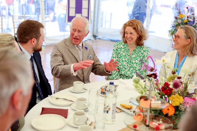The King sitting with guests at a tea party on Crown Pier in St Peter Port