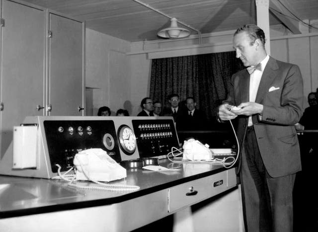Ernest Marples, the postmaster-general, pressing a button to start up Ernie (Electronic Random Number Indicating Equipment) for the first Premium Savings Bonds draw, at Lytham St Annes, Lancashire