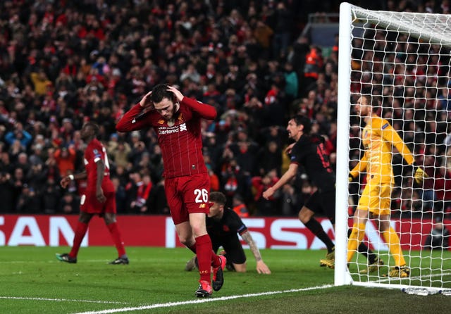 Liverpool’s Andrew Robertson reacts after his header hits the crossbar 
