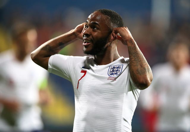 Raheem Sterling pointedly holds his ears as he celebrates scoring against Montenegro