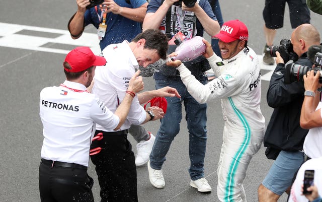 Hamilton celebrates victory with team principal Toto Wolff