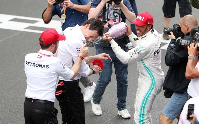 Hamilton celebrates victory with team principal Toto Wolff 