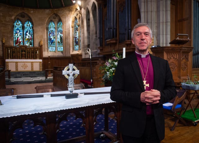 Archbishop of Wales Andrew John with the Cross of Wales ahead of a blessing service