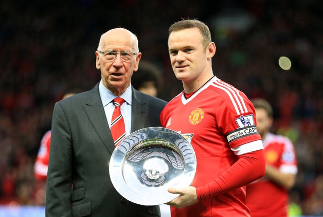 Sir Bobby Charlton presents Wayne Rooney with a trophy marking his 500th appearance for Manchester United