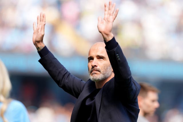 Manchester City manager Enzo Maresca raises his arms to acknowledge supporters
