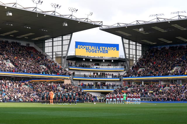 Players from Burnley and Chelsea stand for a moment of reflection and solidarity with Ukraine before kick-off at Turf Moor