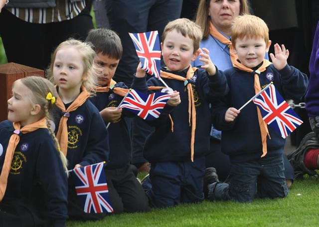 Children eagerly await the royal's arrival