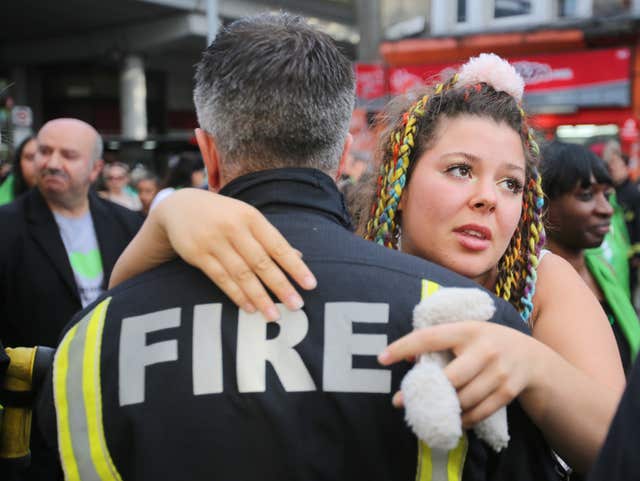 Woman hugs firefighter