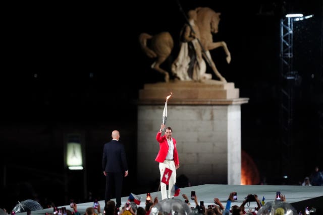 Rafael Nadal carries the Olympic torch at the opening ceremony
