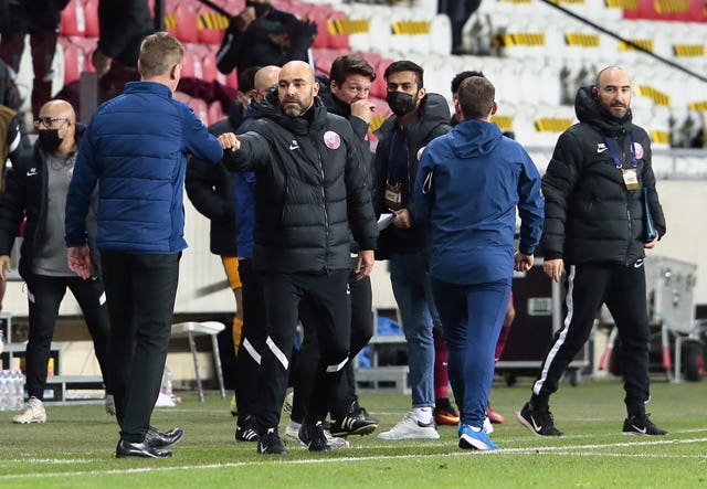 Qatar manager Felix Sanchez, centre, bumps fists with Stephen Kenny after the final whistle