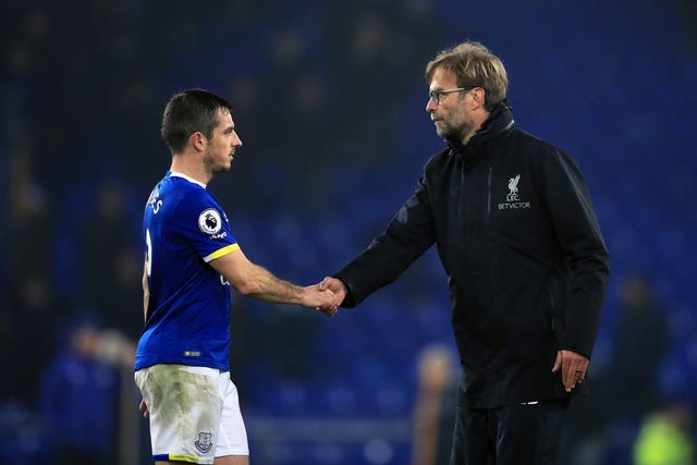 Liverpool manager Jurgen Klopp (right) shakes hands with Everton's Leighton Baines 