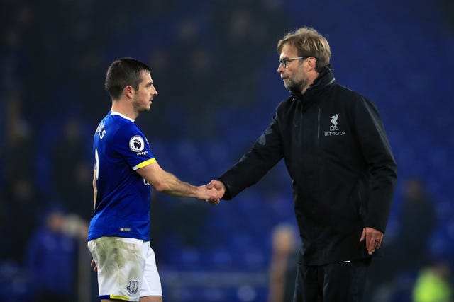 Liverpool manager Jurgen Klopp (right) shakes hands with Everton’s Leighton Baines