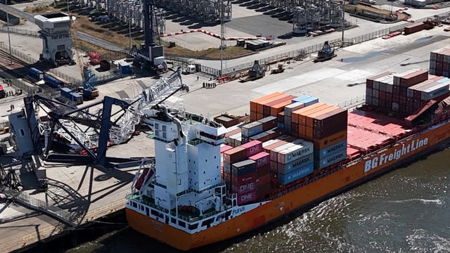A dockside crane lies on the container ship BG Orange operated by BG Freight Line following an incident at the Port of Tyne in South Shields on Sunday